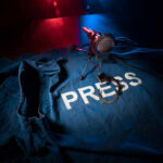 Press jacket and microphone on dark surface