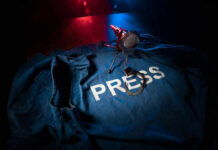 Press jacket and microphone on dark surface