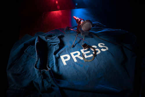 Press jacket and microphone on dark surface