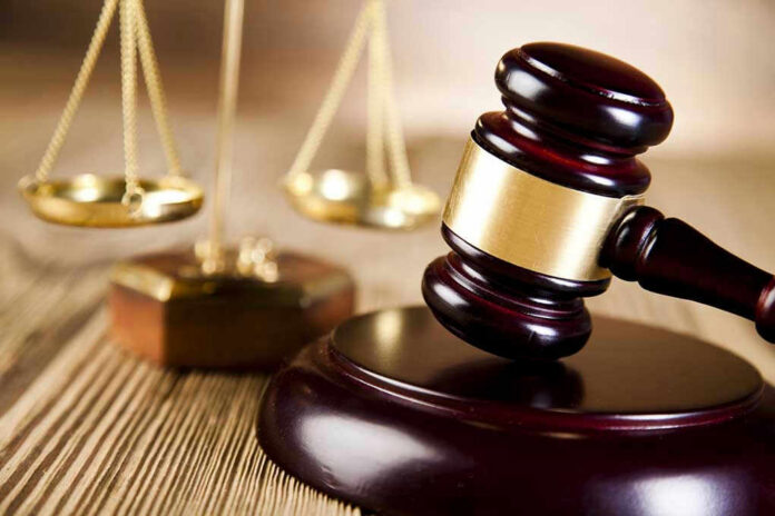 Judges gavel and scales of justice on table.