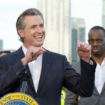 RNC Slams Newsom: Fix California’s Disasters Now! Man speaking passionately at outdoor event with audience