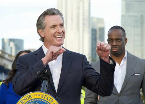 gavin-newsom2387585363jpg Man speaking passionately at outdoor event with audience
