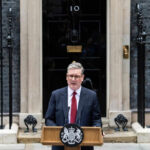 Iran Showdown: UK Bases Host US Strikes Man speaks at podium outside 10 Downing Street.