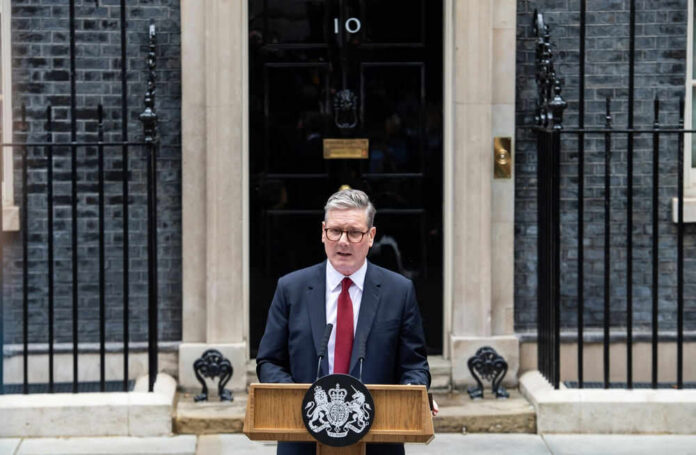 Man speaks at podium outside 10 Downing Street.