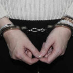 Person in handcuffs wearing a sweater