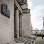 RAF Cyprus EXPLOSION – What Sparked the Attack? Exterior view of the Ministry of Defence building with people walking nearby
