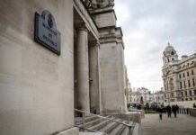 RAF Cyprus EXPLOSION – What Sparked the Attack? Exterior view of the Ministry of Defence building with people walking nearby