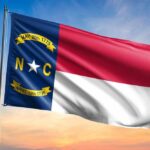 Trump’s Influence DOMINATES North Carolina North Carolina state flag waving against a sunset sky