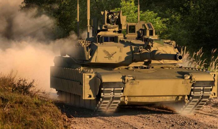 A military tank driving on a dirt path surrounded by trees