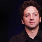 Sleeping Giant UNLEASHED — Tech Fights Back A man with curly hair smiling against a dark background