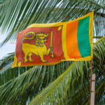 Denied! Sri Lanka Blocks U.S. Jet Landing Sri Lankan flag waving amidst palm trees