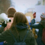 Anti-War Marches Rock London Streets Person holding megaphone at outdoor protest or rally
