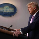 Trump Claims Win — But Iran Keeps Fighting Person speaking at a podium with White House emblem