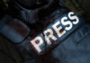 Damaged press bulletproof vest with blood stains.