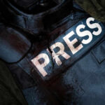 Damaged press bulletproof vest with blood stains.