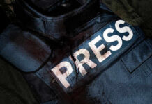 Damaged press bulletproof vest with blood stains.