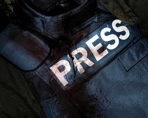 Damaged press bulletproof vest with blood stains.