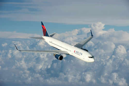 Delta Air Lines airplane flying above the clouds