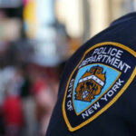 NYC Mayor SLASHES 5,000 Cops For This NYPD officer uniform badge closeup in NYC