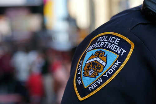 NYPD officer uniform badge closeup in NYC