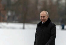 Person in dark coat standing on snowcovered ground