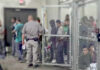 A group of individuals in a detention area with a law enforcement officer