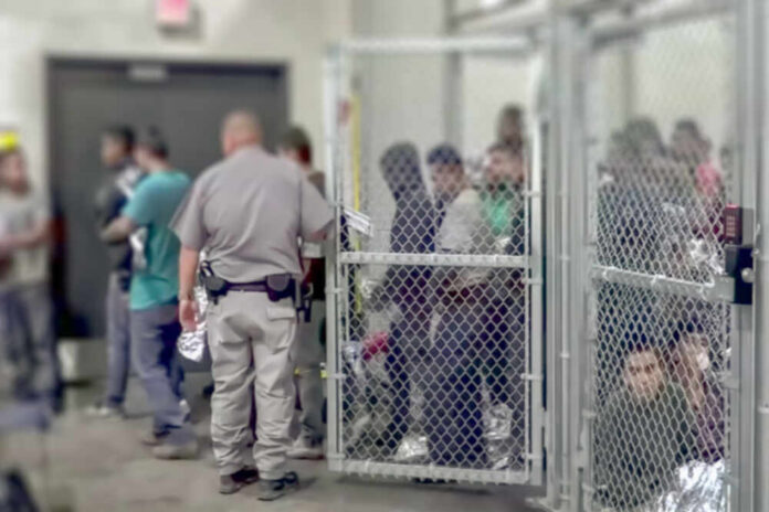 A group of individuals in a detention area with a law enforcement officer