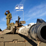 IDF Soldier’s Shocking Act Sparks Global Uproar Soldier saluting from atop a tank with an Israeli flag in the background