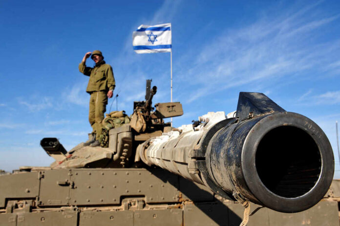 Soldier saluting from atop a tank with an Israeli flag in the background