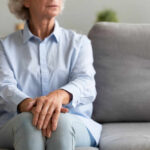 Grieving Mothers TORCH Democrat Mid-Hearing Pivot Elderly woman sitting on a couch with a thoughtful expression