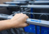 Hand gripping a Walmart shopping cart handle