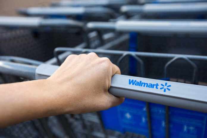Hand gripping a Walmart shopping cart handle