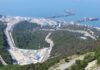 Aerial view of an industrial oil terminal by the coast surrounded by hills