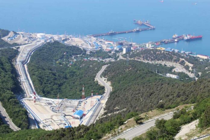 Aerial view of an industrial oil terminal by the coast surrounded by hills