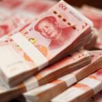 Yuan and Crypto: Iran’s Stealthy Financial Plot Stacks of Chinese banknotes arranged neatly