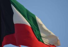 Iran SHATTERS Ceasefire — Kuwait Oil Attacked Kuwait national flag waving in the wind