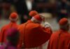 Cardinals in red robes participating in a religious ceremony