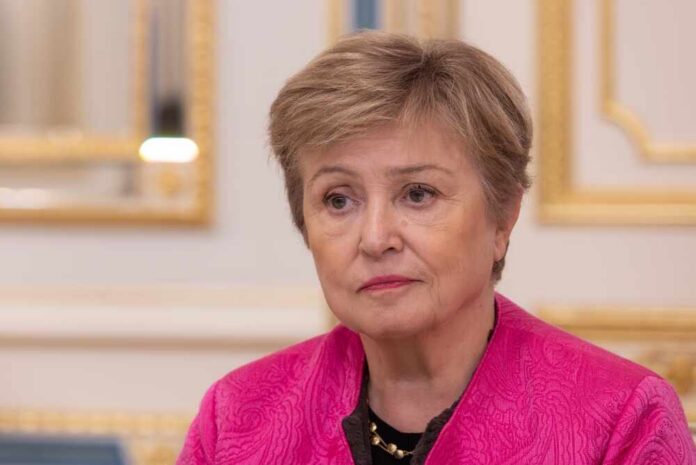 shutterstock_2727863537.jpg A woman in a pink jacket with a serious expression, seated in a formal interior