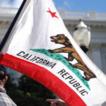 Undocumented Migrants Get Free Gender Surgery California state flag being held up at an outdoor event