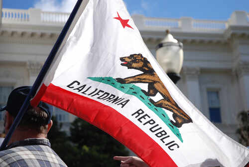 California state flag being held up at an outdoor event
