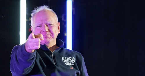 Man pointing with neon lights behind him