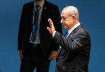 Legal Nightmare: Can Netanyahu Win Against NY Times? I dont know who this person is waving