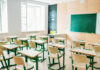 Student EXPULSION Over Pro-ICE Signs Sparks Lawsuit Empty classroom with desks facing a chalkboard