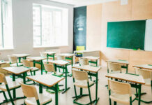 Student EXPULSION Over Pro-ICE Signs Sparks Lawsuit Empty classroom with desks facing a chalkboard
