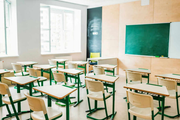 classroom207646682 Empty classroom with desks facing a chalkboard
