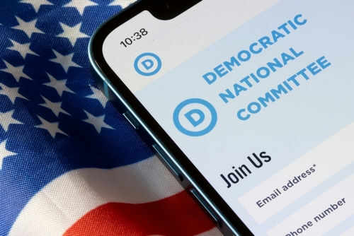 dnc2223653467 Phone screen displaying Democratic National Committee website.