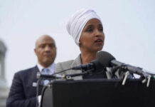 Ilhan Omar TAUNTS DOJ: ‘Show What You’ve Got!’ Two people speaking at a podium with microphones