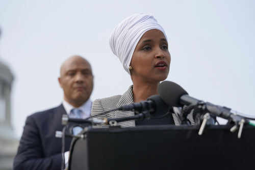 ilhan-omar2012384414 Two people speaking at a podium with microphones