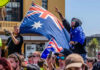 Australia DEFIES China: Forces Rare Earth Sell-Off Crowd with Australian flags at an outdoor gathering