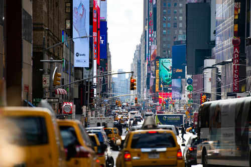 new-york1239405391 Busy city street with taxis and billboards daytime